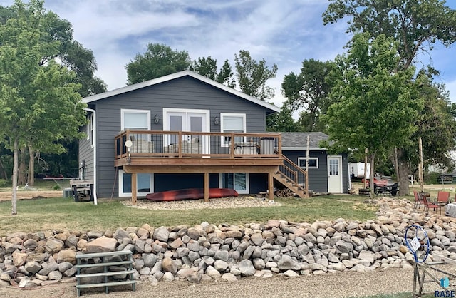 rear view of property featuring a lawn and a wooden deck