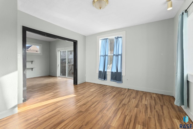 unfurnished room with hardwood / wood-style floors