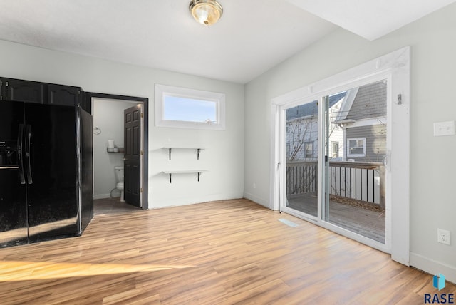 interior space with wood-type flooring and a healthy amount of sunlight