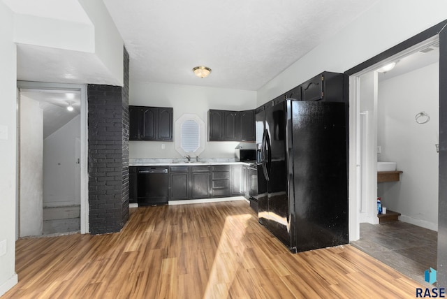 kitchen with sink, light wood-type flooring, and black appliances