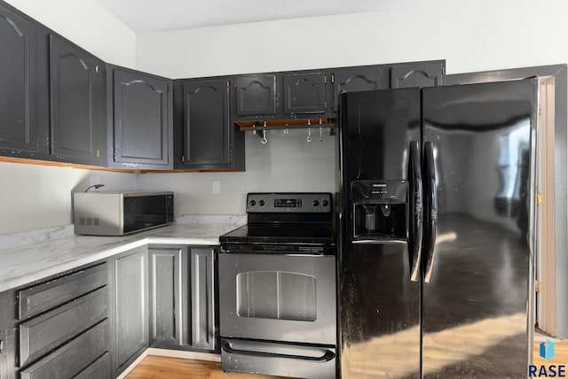 kitchen with stainless steel appliances and light wood-type flooring