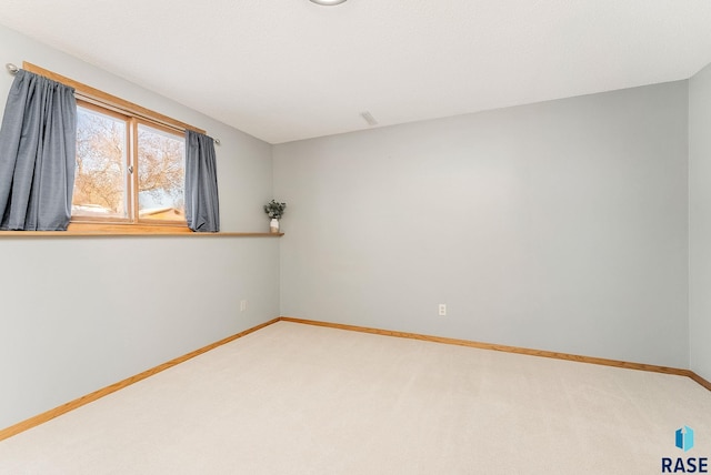 carpeted empty room with visible vents and baseboards