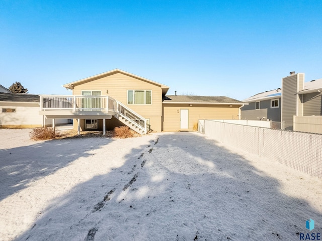 exterior space with stairway, fence, and a wooden deck