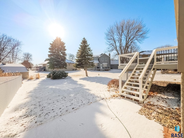 view of yard with stairs, a wooden deck, and fence