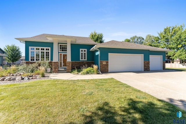 view of front of property with a front lawn and a garage