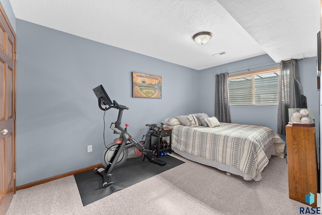 bedroom with a textured ceiling and carpet