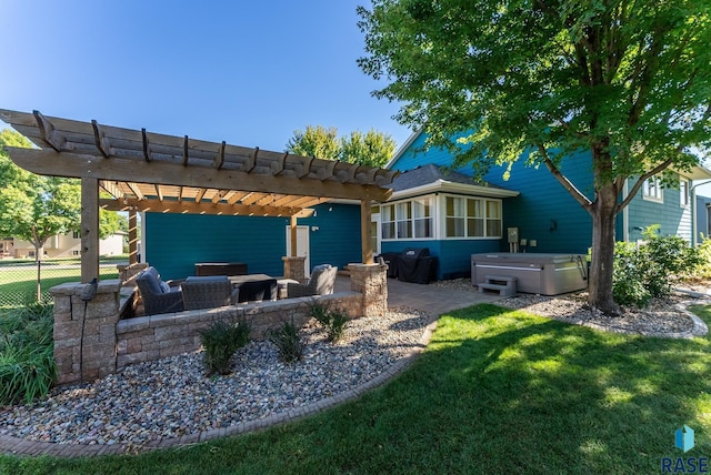 back of house featuring a hot tub, outdoor lounge area, a yard, a patio area, and a pergola