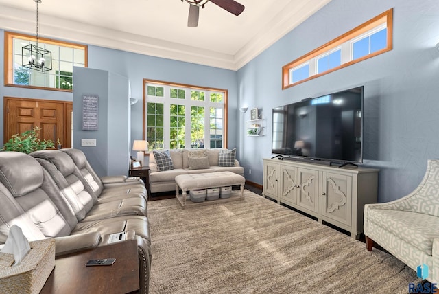 living room featuring ceiling fan with notable chandelier