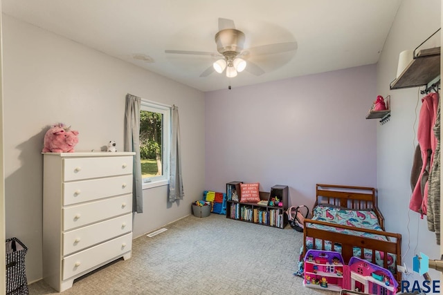 bedroom with light carpet and ceiling fan