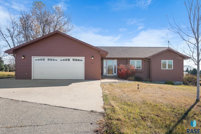 ranch-style home with a front lawn and a garage