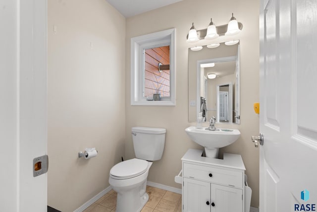 bathroom with sink, tile patterned flooring, and toilet