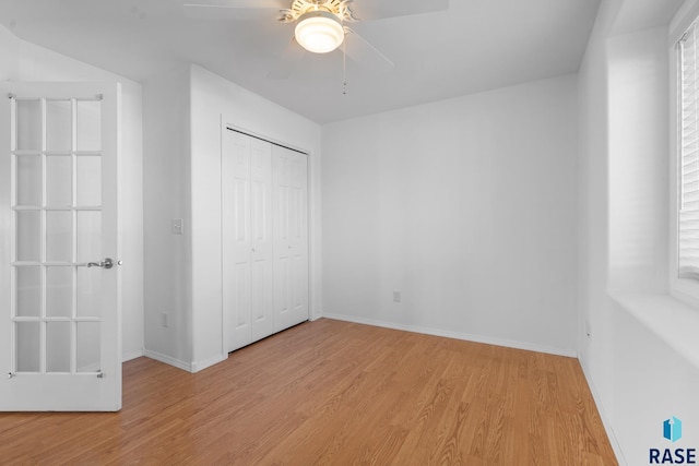 unfurnished bedroom with ceiling fan, a closet, and light hardwood / wood-style flooring