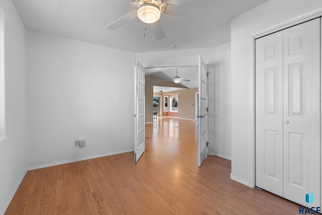 interior space with lofted ceiling, french doors, and light hardwood / wood-style floors