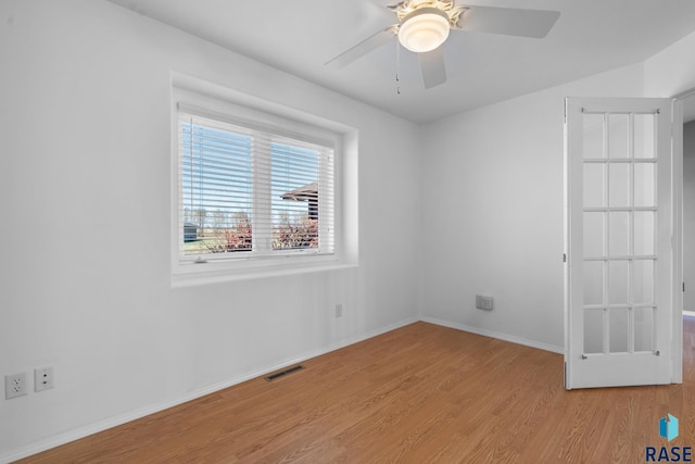 empty room with ceiling fan and light hardwood / wood-style floors