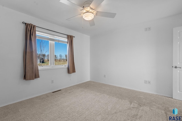 spare room with carpet floors and ceiling fan