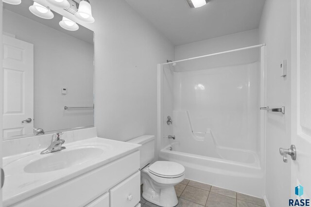 full bathroom with toilet, tile patterned flooring, vanity, and shower / bath combination