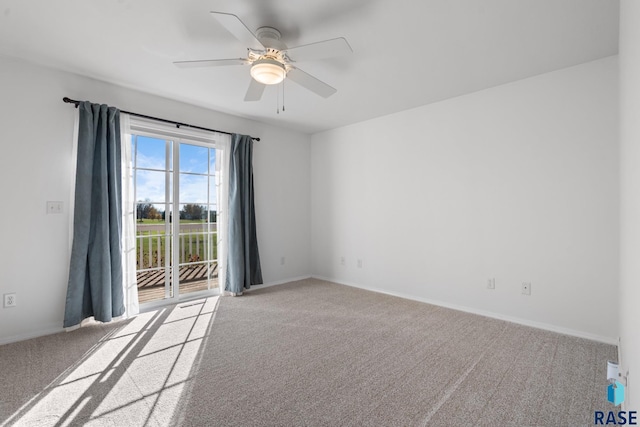 carpeted empty room featuring ceiling fan