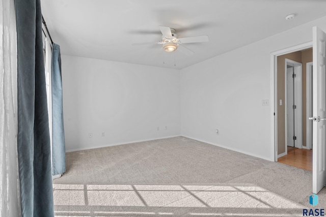 carpeted empty room with ceiling fan