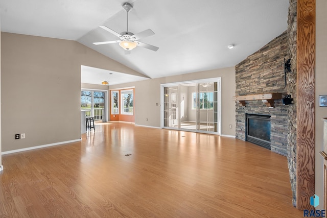 unfurnished living room with a fireplace, ceiling fan, vaulted ceiling, and light wood-type flooring