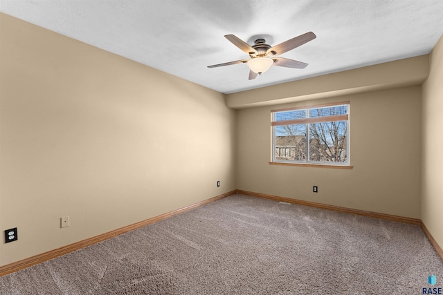 carpeted spare room with ceiling fan