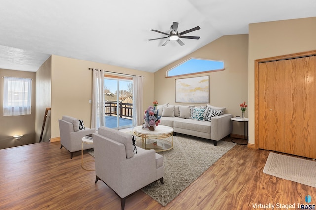 living room with ceiling fan, hardwood / wood-style floors, and vaulted ceiling