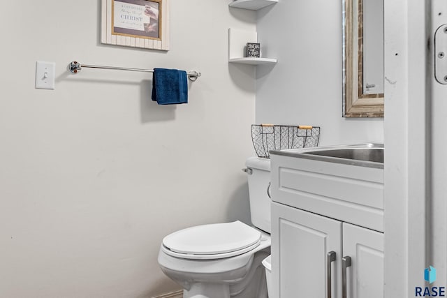 bathroom featuring toilet and vanity