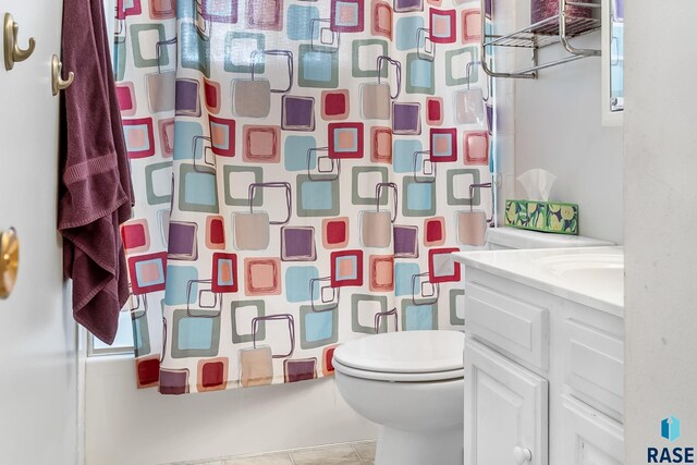 full bathroom featuring tile patterned flooring, toilet, vanity, and shower / tub combo with curtain