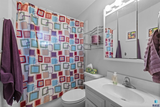 bathroom featuring toilet and vanity