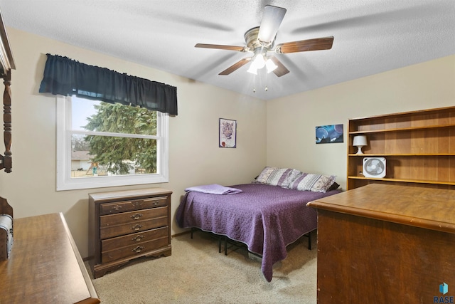 carpeted bedroom with a textured ceiling and ceiling fan