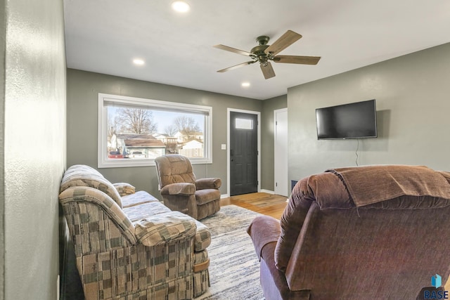 living room with ceiling fan and light hardwood / wood-style flooring