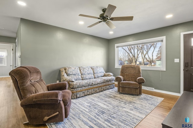 living room with ceiling fan and light wood-type flooring