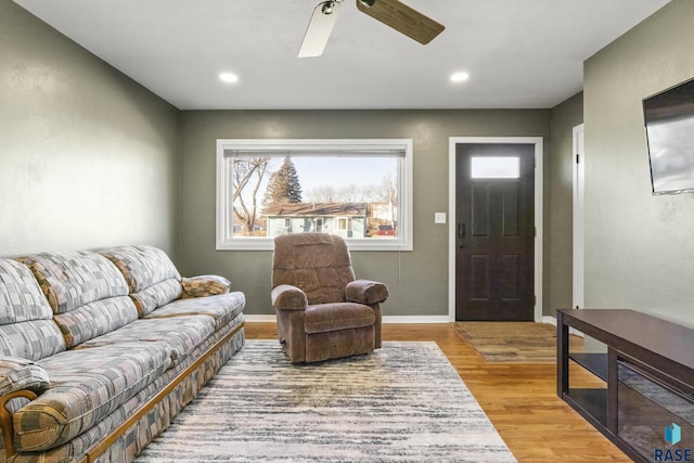 living room with light hardwood / wood-style floors and ceiling fan