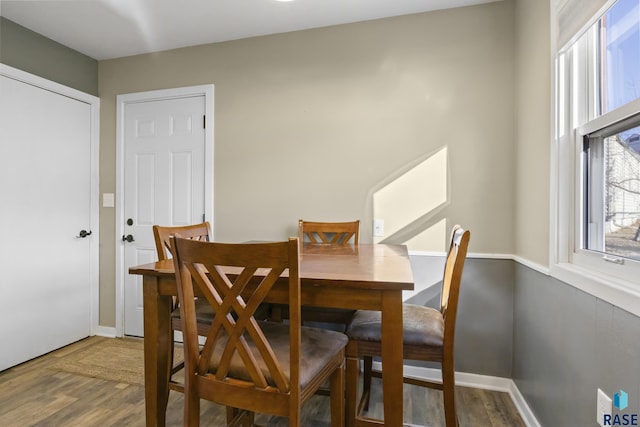 dining space with wood-type flooring