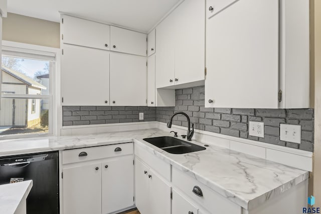 kitchen with sink, white cabinetry, backsplash, and black dishwasher