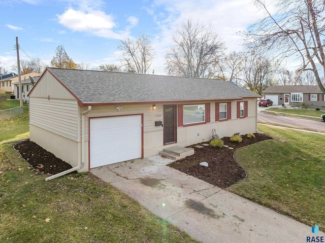 ranch-style home with a front yard and a garage