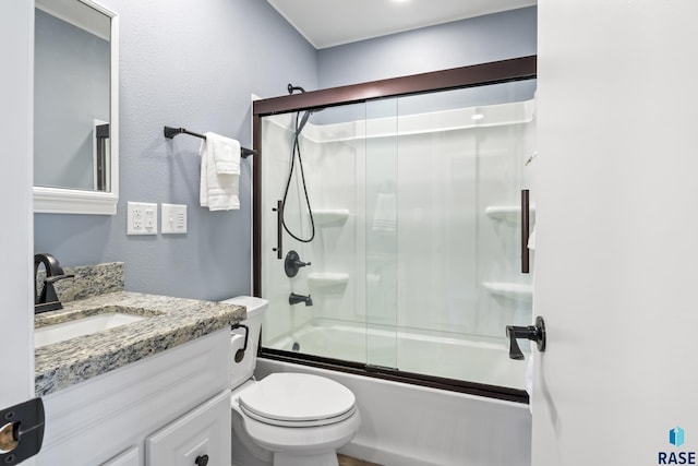 full bathroom featuring bath / shower combo with glass door, vanity, and toilet