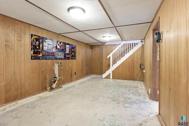 basement featuring wood walls