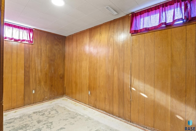 basement featuring wooden walls