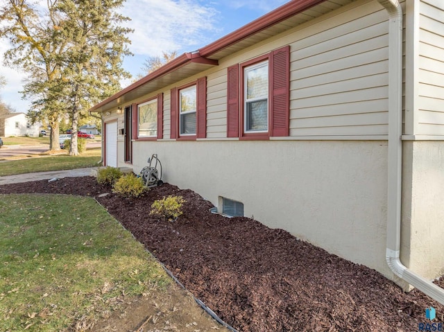 view of property exterior with a lawn