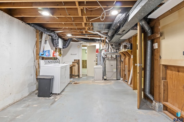 basement featuring independent washer and dryer and heating unit