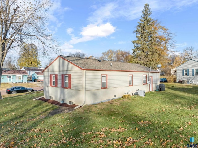 view of side of home with a yard