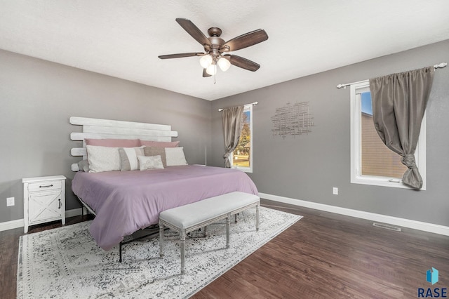 bedroom featuring dark hardwood / wood-style flooring and ceiling fan