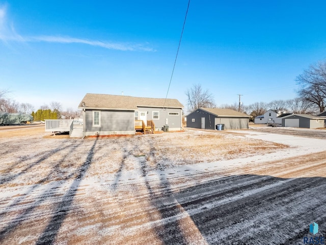 back of house with an outbuilding