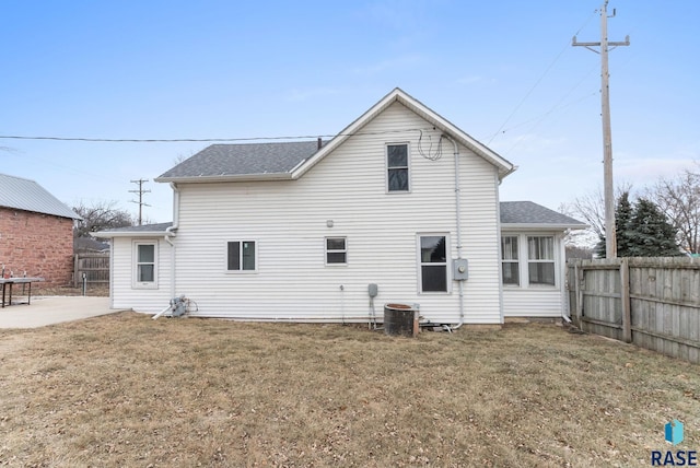 back of house with a patio area, cooling unit, and a lawn