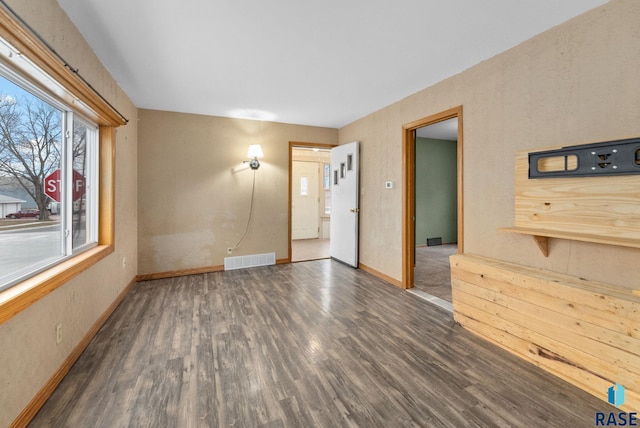 empty room with dark wood-type flooring