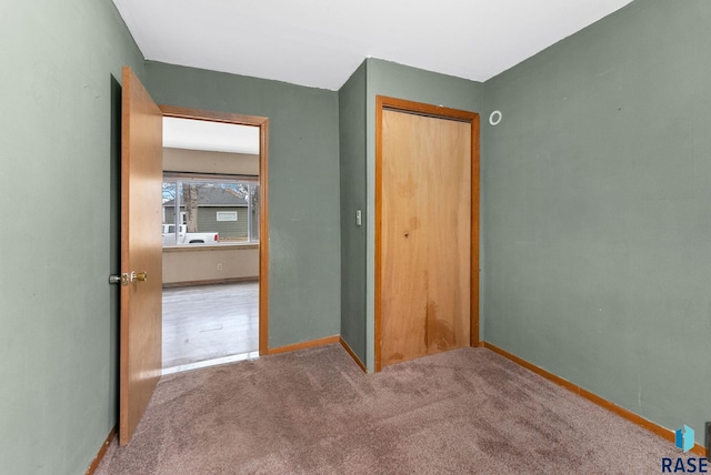 unfurnished bedroom with a closet and carpet floors