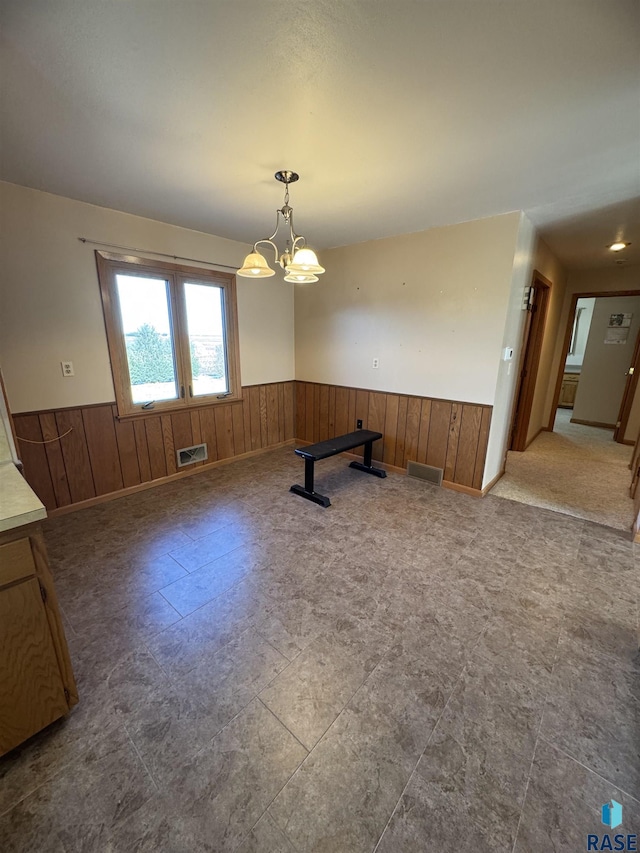 unfurnished dining area featuring an inviting chandelier