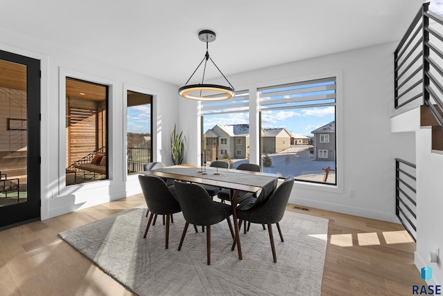 dining area featuring light hardwood / wood-style floors and plenty of natural light