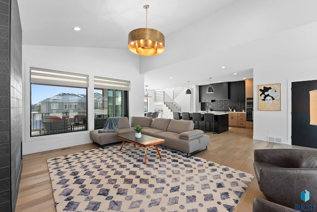 living room featuring hardwood / wood-style flooring and vaulted ceiling