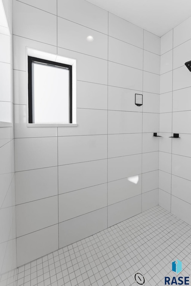 bathroom with tiled shower